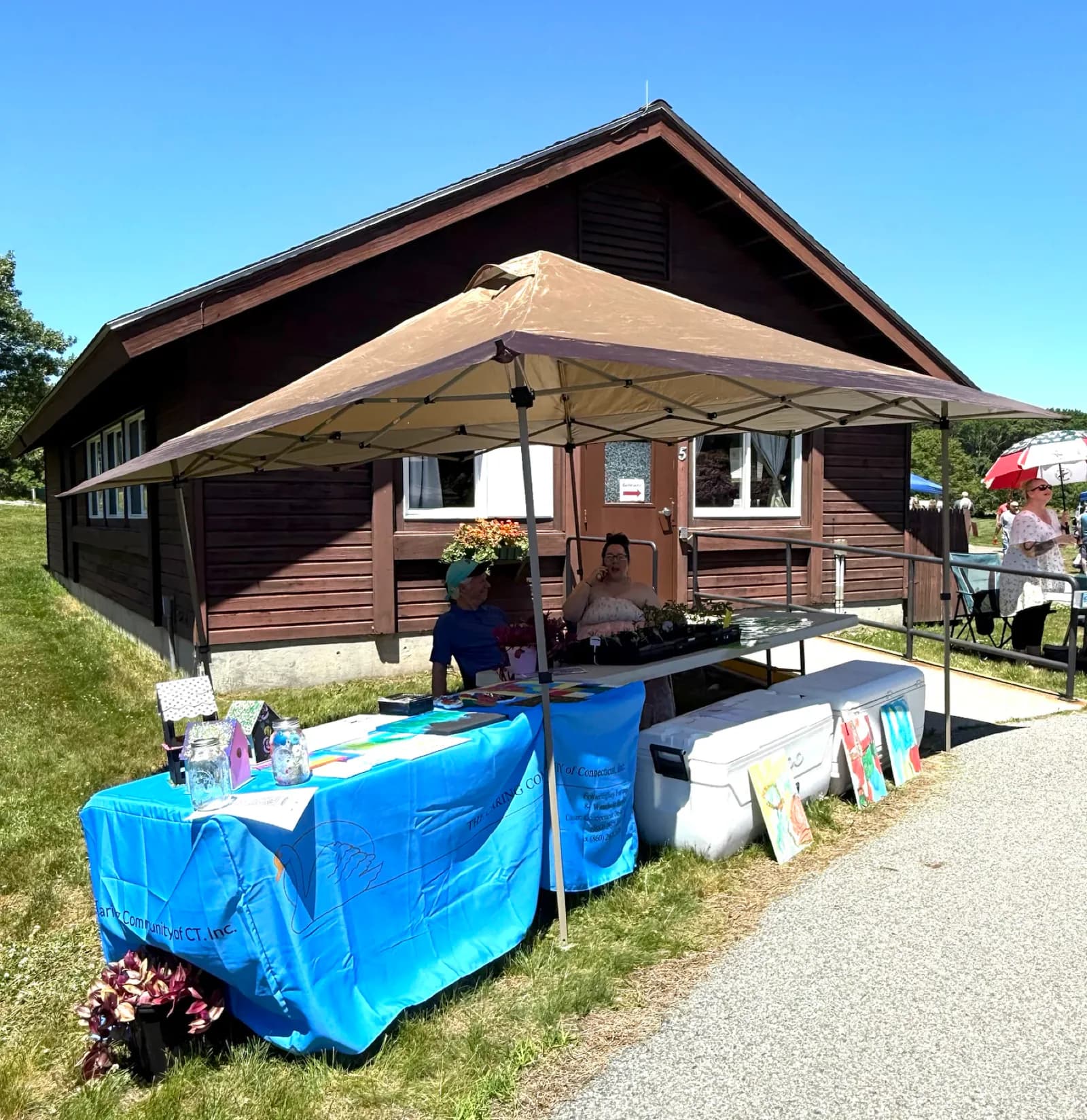 Outdoor Caring Community table set up under a canopy