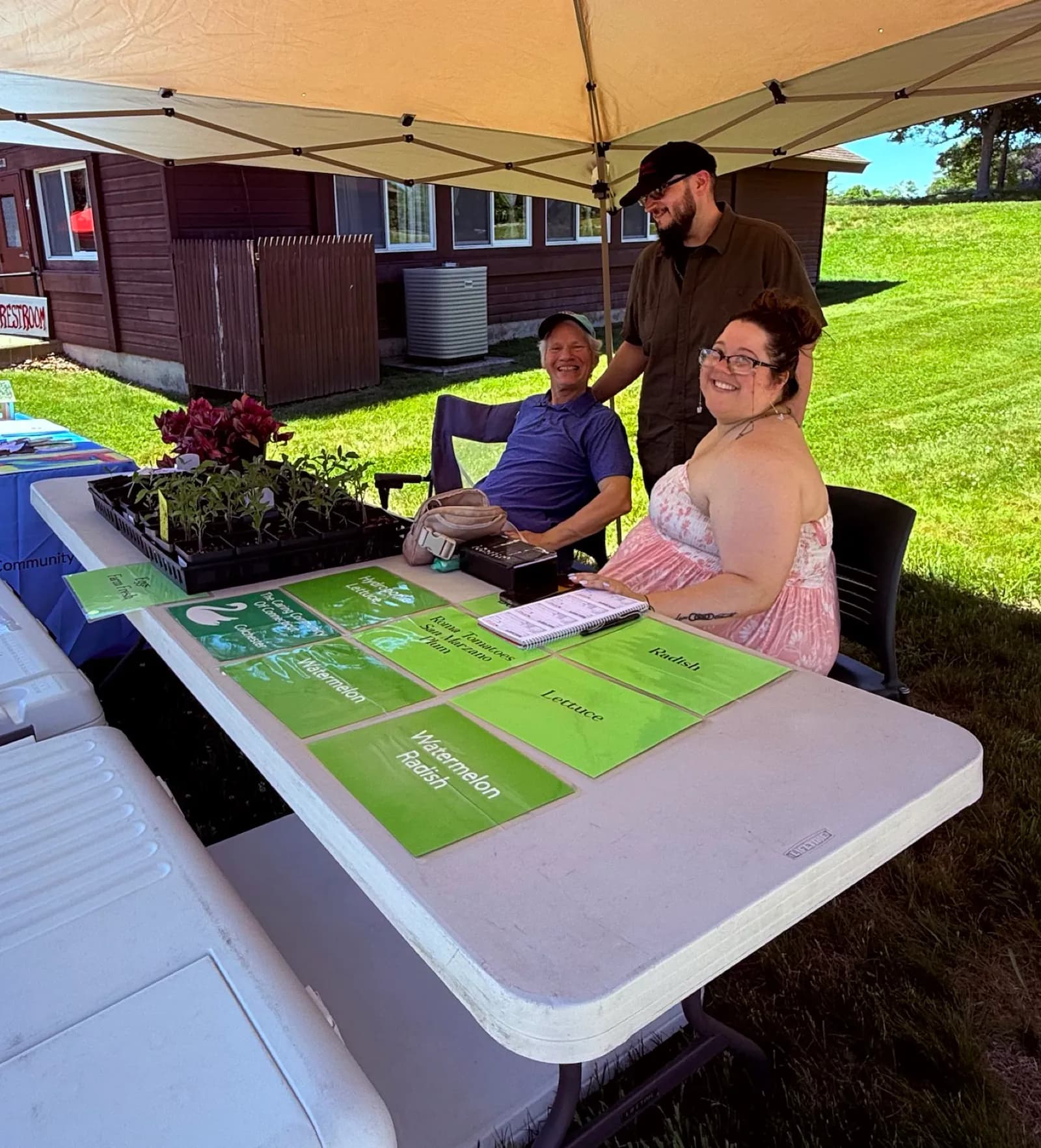 Garden cards and plants arranged on an outdoor community table